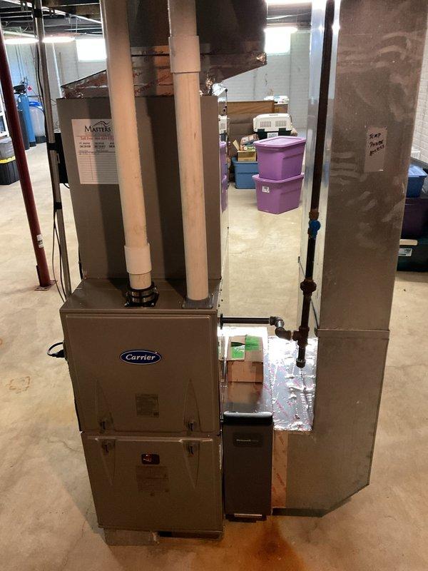 Completed full HVAC system installation in basement mechanical room, including Carrier 59TP7A080V17-16 Performance 97 Series two-stage gas furnace with 97% AFUE rating, Carrier 26SCA436N003 Comfort Series single-stage 3-ton air conditioner, and Carrier CVAVA4217XMA evaporator coil. Installed Honeywell FocusPro thermostat for system control and integrated Honeywell 4-inch media air cleaner for enhanced filtration. Reconnected existing supply and return ductwork to new equipment, installed new electrical disconnect and whip for outdoor unit, and completed all refrigerant line connections with proper insulation. Mounted furnace on concrete blocks with condensate pump for proper drainage, ran PVC condensate drain lines vertically through ceiling joists, and verified all electrical connections meet code requirements. Tested two-stage furnace operation, confirmed proper airflow across evaporator coil, and verified refrigerant charge on air conditioning system. Explained system operation to h