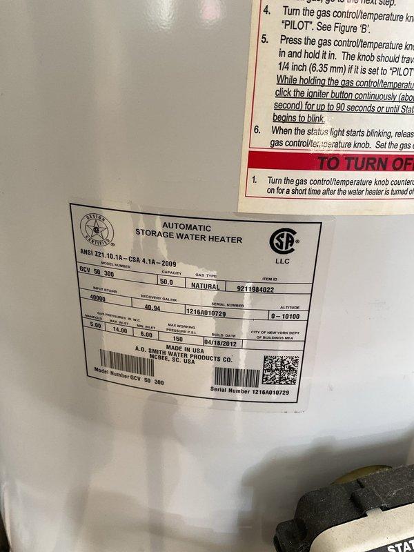Provided estimate for replacement of existing 50-gallon A.O. Smith natural gas water heater located in garage. Current unit manufactured in April 2012 is operational but aging, and homeowner is planning for proactive replacement. Documented existing installation including water heater mounted on stand with copper supply connections, proximity to water softener system, and proper venting configuration.