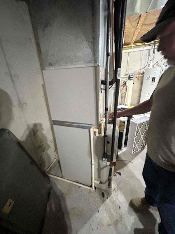 Performed comprehensive site assessment of existing Frigidaire HVAC system located in basement mechanical room to provide equipment replacement estimate. Documented current air handler configuration, including accessible copper refrigerant lines, electrical connections, and ductwork routing. Evaluated installation space constraints, concrete floor conditions, and access requirements through utility room entry point. Photographed equipment specifications, mechanical components, and surrounding infrastructure to develop accurate replacement proposal and ensure proper sizing for new system installation.