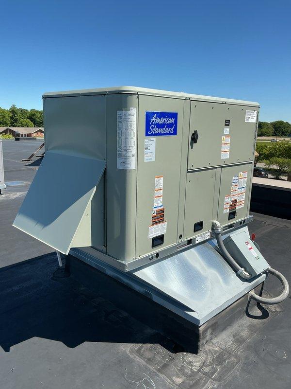 Removed and replaced existing Carrier 5-ton heat pump RTU with new American Standard WSK060A3S0G 5-ton heat pump RTU featuring R454b refrigerant and electric strip heat, rated for 208/230V 3-phase operation. Installed curb adapter to accommodate new unit footprint, integrated economizer for energy-efficient air-side operation, and mounted Honeywell T6 programmable thermostat for precise temperature control. Added external electrical disconnect box as the replacement unit does not include an integral disconnect like the previous equipment. Completed system startup, verified proper operation of heat pump cycle, auxiliary heat staging, and economizer function.