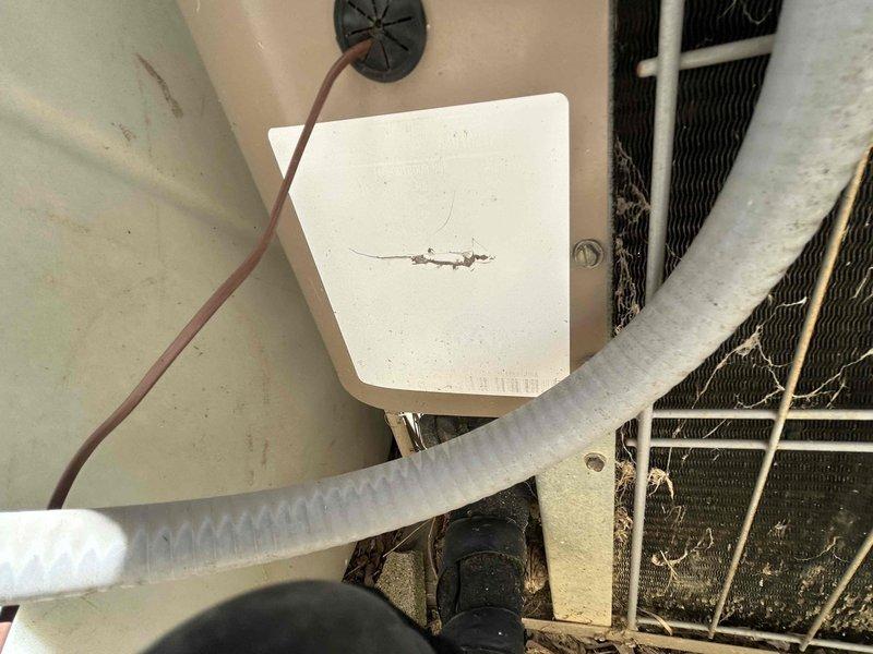 Conducted comprehensive system evaluation for complete HVAC replacement estimate. Assessed existing outdoor condensing unit showing significant age-related wear, including heavily soiled condenser coils with accumulated dirt and debris buildup affecting heat transfer efficiency. Inspected refrigerant line set with foam insulation, electrical junction box, and associated wiring connections. Evaluated indoor air handler components including drain lines, copper refrigerant piping, and ventilation system infrastructure within mechanical space. Documented all equipment conditions through photographic evidence to support replacement recommendation due to system age and declining operational efficiency.