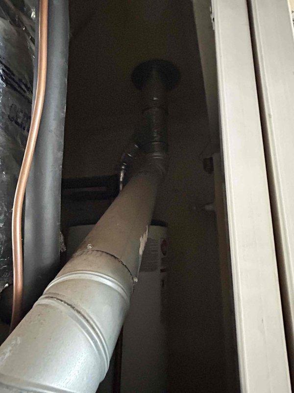 Conducted comprehensive system evaluation for complete HVAC replacement estimate. Assessed existing outdoor condensing unit showing significant age-related wear, including heavily soiled condenser coils with accumulated dirt and debris buildup affecting heat transfer efficiency. Inspected refrigerant line set with foam insulation, electrical junction box, and associated wiring connections. Evaluated indoor air handler components including drain lines, copper refrigerant piping, and ventilation system infrastructure within mechanical space. Documented all equipment conditions through photographic evidence to support replacement recommendation due to system age and declining operational efficiency.