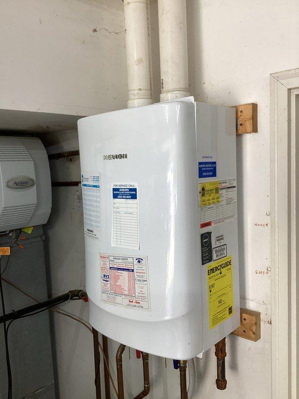 Responded to service call for tankless water heater displaying red error light and complete loss of hot water production. Unit had been previously flushed with vinegar solution by homeowner, which temporarily restored function for several days before failure recurred. Initial troubleshooting revealed unit was non-responsive to standard reset procedures via power cycling. Conducted comprehensive diagnostic inspection of wall-mounted tankless unit, examining all electrical connections, venting system including dual PVC exhaust pipes, and copper supply/return plumbing connections. Assessed control board error codes and evaluated heat exchanger condition for potential scale buildup or component failure. Documented existing installation configuration including proximity to HVAC humidifier system and current plumbing arrangement with multiple shut-off valves. Photographed unit condition, manufacturer labels, and associated plumbing infrastructure for service records. Based on diagnostic find