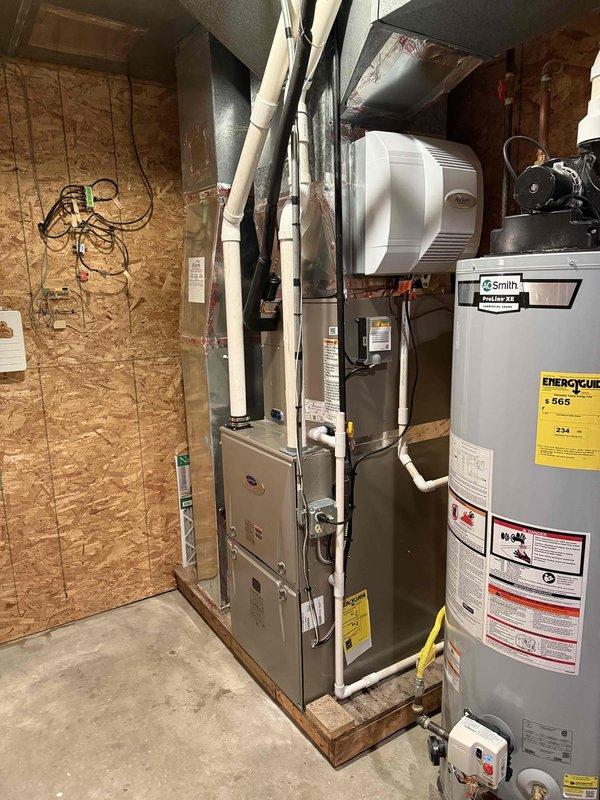 Completed full HVAC system replacement including installation of Carrier Infinity Series 98% AFUE modulating gas furnace with LP conversion kit, Carrier Comfort Series single-stage air conditioner, evaporator coil, and Infinity System Controller with WiFi capability. Installed Honeywell 4" media air cleaner and reconnected all existing supply and return ductwork to new equipment in basement utility area. Removed and recycled old HVAC equipment, then set outdoor condenser unit on new 2" PVC pad with pea gravel base against exterior wall. Flushed, pressure tested, and reconnected to existing refrigerant line set. Installed floor protection during work and cleaned installation areas upon completion. Registered all equipment warranties and provided system operation explanation including thermostat programming and controls. All work performed to code with required permits obtained.