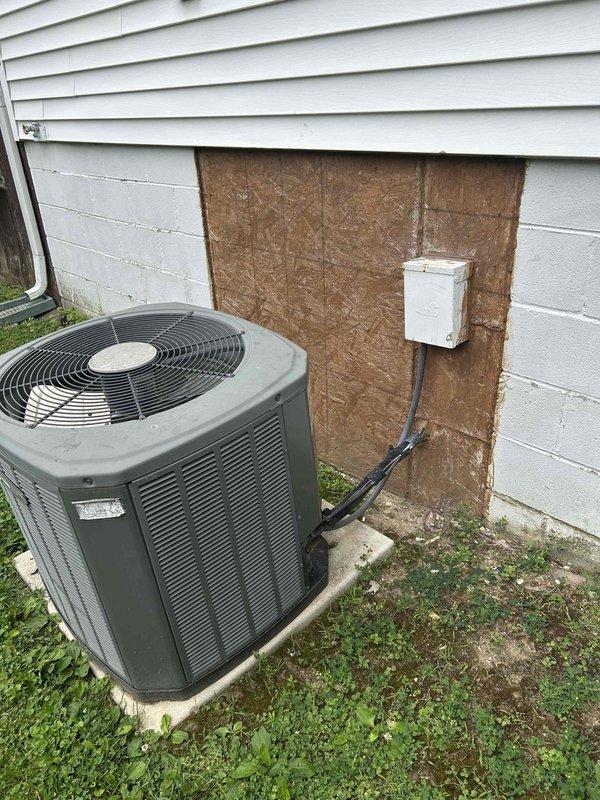 Conducted comprehensive site assessment for HVAC system replacement at residential property. Documented existing equipment including outdoor condensing unit with electrical disconnect and indoor water heater/utility equipment in basement area. Evaluated current system configuration, electrical connections, and installation conditions to provide accurate replacement estimate for complete HVAC system upgrade.