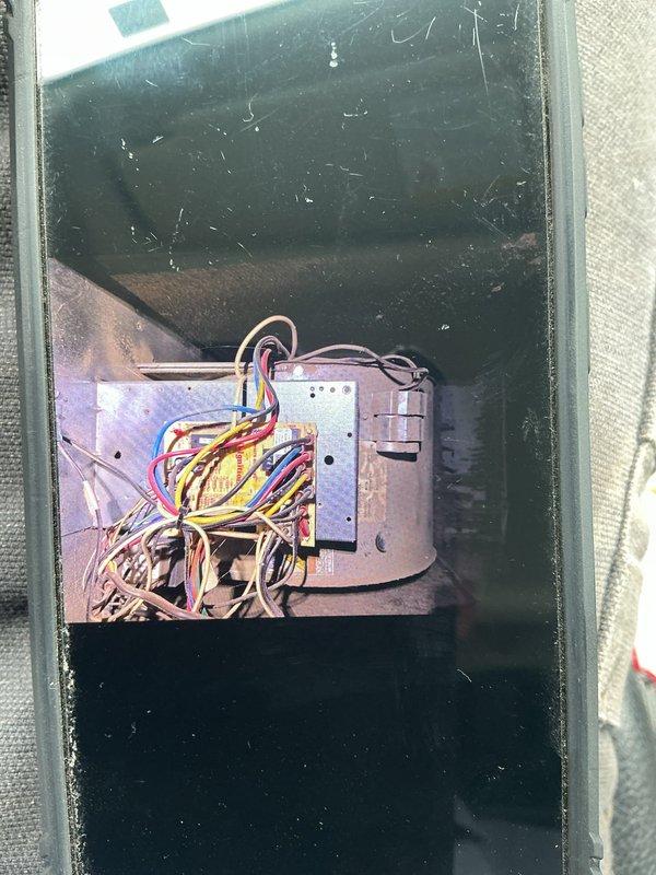 Responded to service call regarding water leaking from light fixture below attic-mounted gas furnace. Upon inspection, discovered condensate drain system blockage causing water overflow from the air handler unit. Inspected blower assembly and confirmed excessive moisture accumulation around blower wheel and housing, with visible water pooling in drain pan. Cleared condensate drain line obstruction, verified proper drainage flow, and confirmed no further leaking. System tested and returned to normal operation.