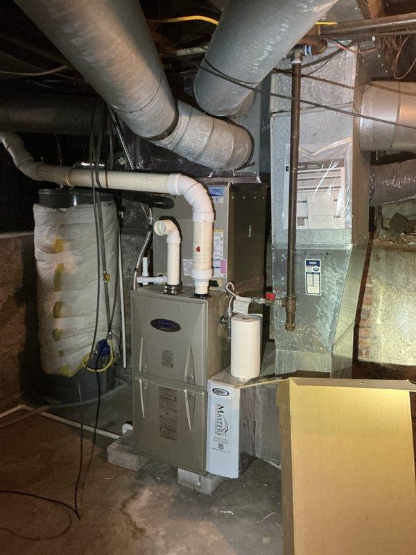Conducted on-site evaluation of existing single-zone HVAC system to provide estimate for adding supplemental zone to improve second-floor cooling capacity. Assessed current furnace, air handler, and ductwork configuration in basement mechanical room. Documented existing system layout including main supply trunk lines, flexible ductwork runs, and available space for potential zone damper installation and additional supply branches to serve upstairs areas.