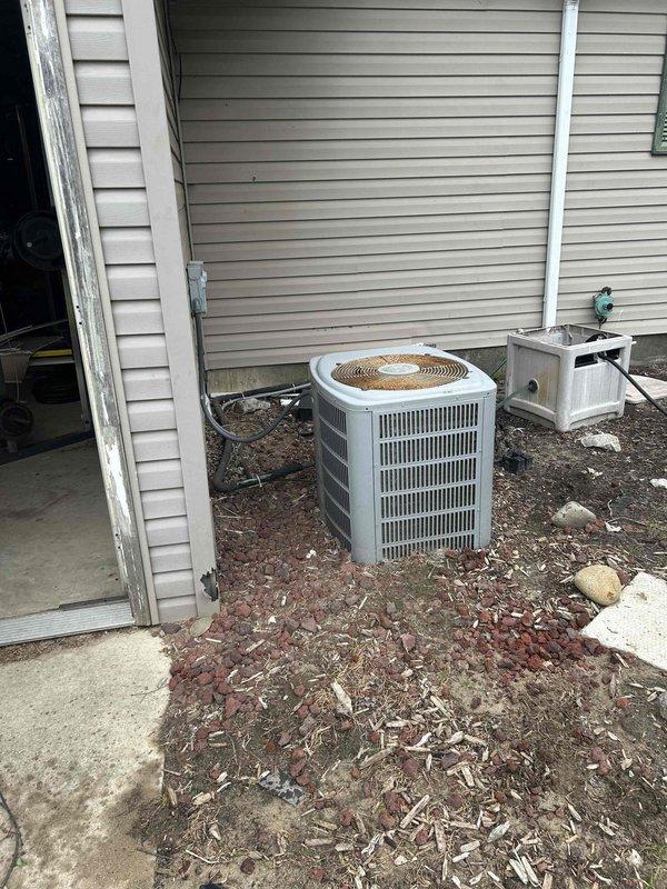 Conducted on-site assessment for complete HVAC system replacement at 1800 square foot residential property with crawl space foundation. Evaluated existing outdoor condensing unit and indoor furnace system for replacement specifications. Documented current equipment configuration including outdoor AC unit with disconnect box, electrical service connections with dual meter setup, and conduit routing. Assessed installation requirements for new furnace and central air system, noting existing equipment removal considerations due to interior water damage requiring floor repairs prior to new unit installation. Provided consultation on tankless water heater conversion as additional upgrade option. Captured photographic documentation of existing exterior HVAC components, electrical service infrastructure, foundation conditions, and equipment placement locations to develop comprehensive replacement proposal for complete heating and cooling system upgrade.