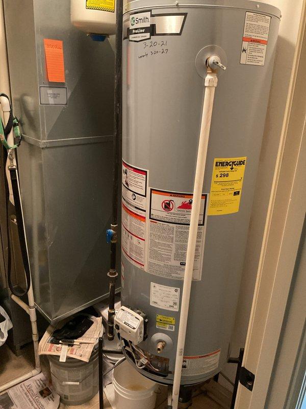 Replaced leaking 50-gallon residential water heater in utility room under warranty coverage. Removed failed unit and installed new A.O. Smith water heater with Honeywell gas control valve, verified all plumbing connections, tested gas lines for leaks, and confirmed proper operation of pilot light and burner assembly. Unit is functioning correctly with appropriate temperature settings and all safety controls operational.