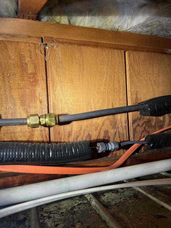 Responded to no cooling complaint on 5-year-old Mitsubishi mini split system serving pool house that had previously been serviced by two other companies without resolution. Performed diagnostic evaluation of the system, which was functioning properly in heating mode but failing to cool. Inspected outdoor condenser unit, indoor air handler, refrigerant lines, and electrical connections. Accessed attic space to examine refrigerant piping, condensate drainage, and control wiring between indoor and outdoor units. Documented system installation and component locations with photographs for reference. Customer requested quote for potential replacement if repair not feasible given system age and previous unsuccessful service attempts.