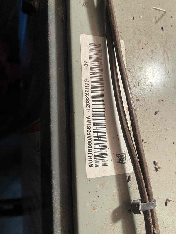 Responded to no cooling complaint on residential HVAC system. Upon arrival, confirmed system was running but failing to provide adequate cooling to home. Advised homeowner to power down unit to prevent potential compressor damage. Performed visual inspection of outdoor condensing unit, documenting equipment model and serial number information via barcode label. Unit showed signs of age-related wear consistent with 10+ years of operation, including surface discoloration, minor corrosion, and accumulated debris on cabinet surfaces. Photographed equipment nameplate and identification tags for service records. System components located at ground level with no attic installation confirmed prior to visit.
