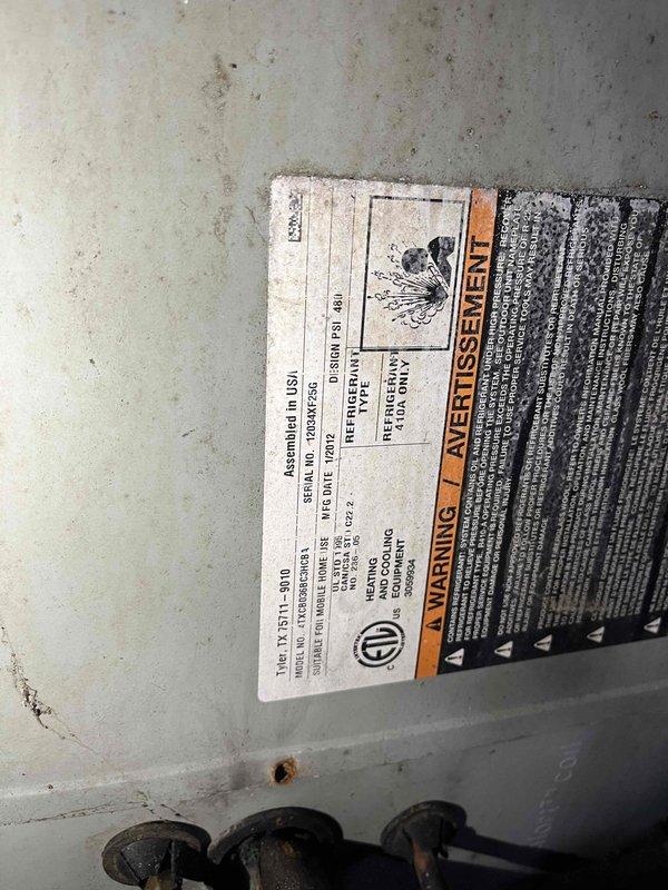 Responded to no cooling complaint on residential HVAC system. Upon arrival, confirmed system was running but failing to provide adequate cooling to home. Advised homeowner to power down unit to prevent potential compressor damage. Performed visual inspection of outdoor condensing unit, documenting equipment model and serial number information via barcode label. Unit showed signs of age-related wear consistent with 10+ years of operation, including surface discoloration, minor corrosion, and accumulated debris on cabinet surfaces. Photographed equipment nameplate and identification tags for service records. System components located at ground level with no attic installation confirmed prior to visit.