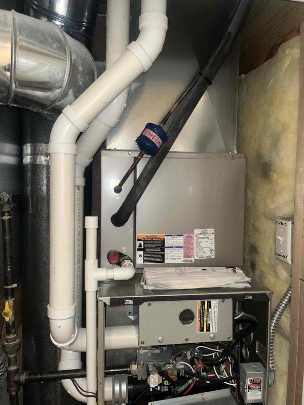 Responded to no cooling complaint on residential air conditioning system. Upon arrival, located outdoor condensing unit surrounded by landscaping and performed diagnostic evaluation of both outdoor and indoor equipment. Inspected furnace/air handler with access panel removed, examined internal components including control board, wiring connections, and mechanical assemblies. Assessed system operation and identified cause of cooling failure, completing necessary repairs to restore proper function.