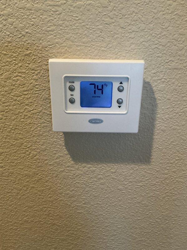 Conducted equipment evaluation for non-cooling air conditioning system. Documented existing Carrier thermostat and outdoor condenser unit condition. Scheduled replacement estimate consultation to provide system options and recommendations for complete AC replacement.