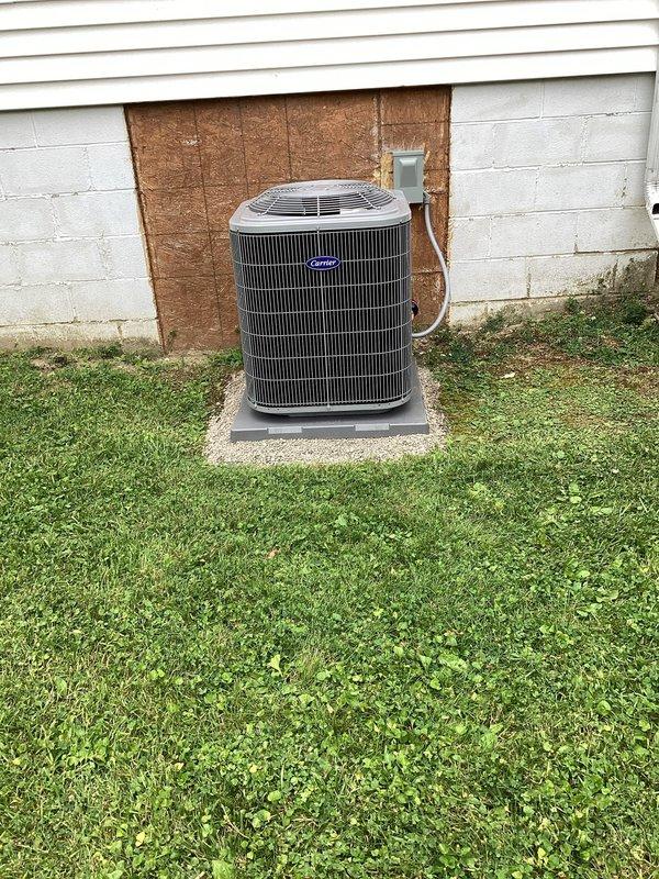 Completed full HVAC system installation including Carrier 26SCA424N003 Comfort Series single-stage air conditioner (2-ton), Carrier CVAVA3017XMA evaporator coil, and Carrier 59TP7A060V17-16 Performance 97 Series two-stage gas furnace with 97% AFUE rating. Removed and recycled existing equipment, then installed new furnace with #2 installation kit for 80-90 efficiency upgrade. Reconnected to existing line set after performing complete flush and pressure test to ensure system integrity. Installed Honeywell 4" media air cleaner for improved indoor air quality and mounted new 2" PVC condenser pad with pea gravel base for outdoor unit stability. Set up Honeywell Elite Pro S1200 programmable thermostat, programmed system parameters, and provided comprehensive operation explanation to homeowner. Reconnected all existing supply and return ductwork, verified proper airflow throughout system, and submitted utility rebate paperwork. Applied floor protection throughout work areas and completed tho