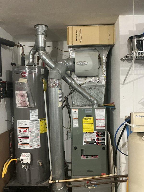 Conducted on-site assessment of existing HVAC system for replacement estimate. Evaluated current equipment including furnace/air handler, outdoor condensing unit (KING brand), and associated ductwork in basement mechanical room. Documented system configuration, equipment specifications, and installation requirements. Photographed existing components including water heater proximity, electrical connections, ductwork layout, and outdoor unit placement on concrete pad. Provided comprehensive replacement recommendations based on current system condition and home requirements.