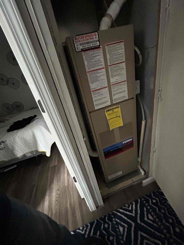 Provided comprehensive estimate for complete HVAC system replacement including furnace, air conditioning unit, and ductwork replacement following damage requiring remediation. Inspected existing York air handler unit and associated PVC condensate drainage system in utility closet, finding no visible water damage or leakage in accessible areas beneath the structure. Recommended smoke testing of drainage system to identify potential air leaks, with customer approving procurement of materials and scheduling return visit with two technicians to perform diagnostic smoke test using tall ladder and 3" fernco coupling for proper system evaluation.