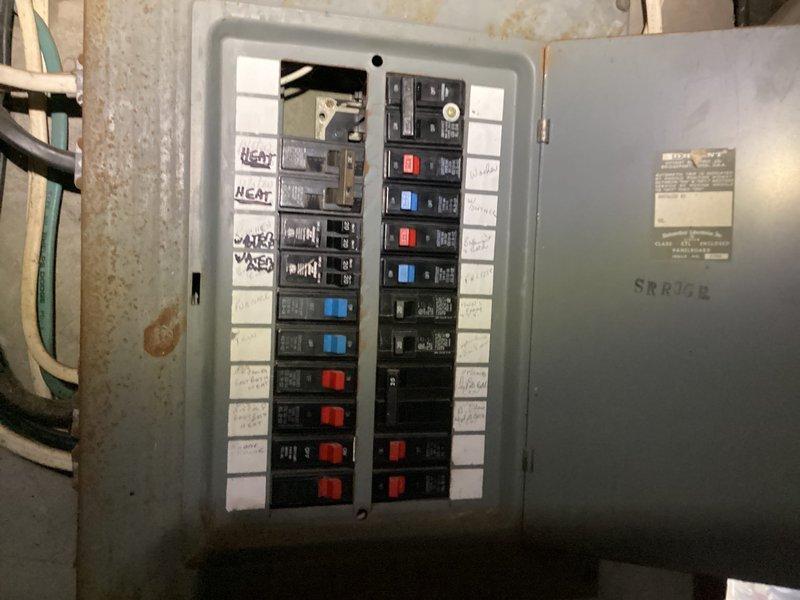 Completed preventive maintenance tune-up on air conditioning system in cooling mode. Inspected electrical panel, wiring connections, and associated components in utility area and attic space. Documented system conditions with photos showing electrical infrastructure and cable routing for maintenance records.