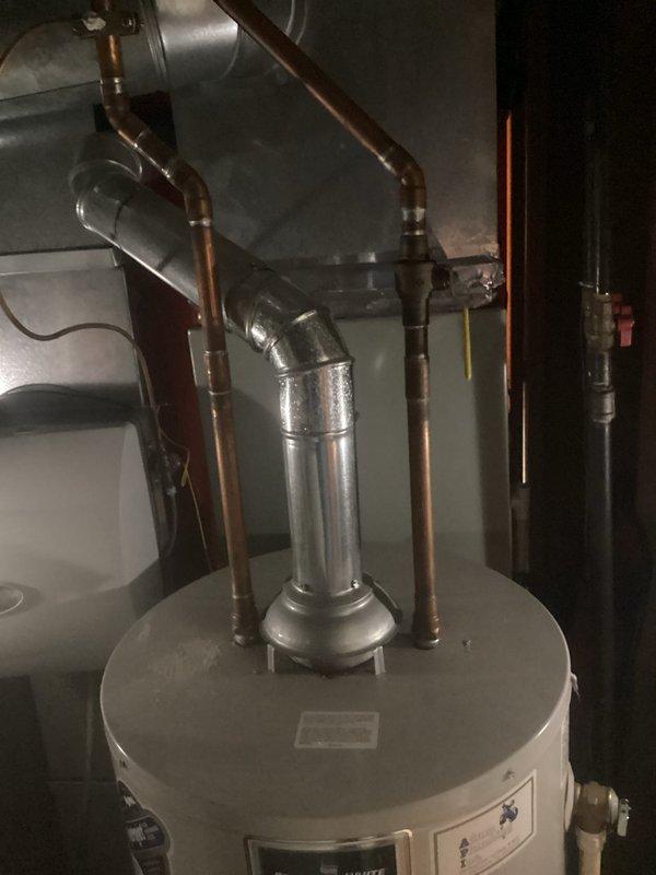Provided estimate for replacement of gas-fired tank-style water heater with pilot light failure. Existing unit located in basement showed signs of age and pilot would not remain lit, indicating likely thermocouple or gas valve failure. Assessed current installation including copper supply piping, venting configuration, and gas line connections to determine scope of replacement work.