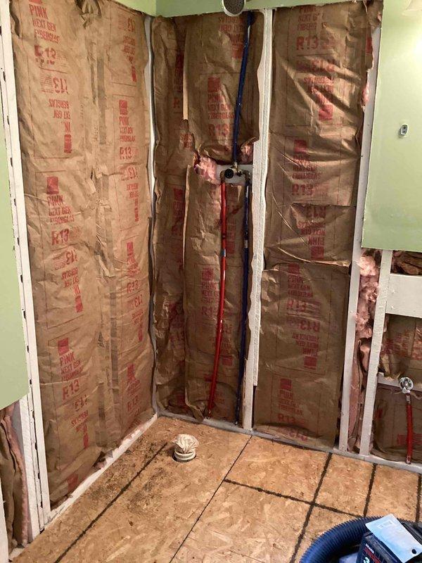 Conducted on-site assessment and provided estimate for 39x39 corner shower installation in residential bathroom undergoing renovation. Evaluated existing rough plumbing including copper water lines and PEX supply piping, confirmed proper placement of 12x12 center drain location in tiled floor. Quoted complete shower unit with frosted or clear door option featuring nickel finish trim hardware per specifications, door code 3230. Documented exposed wall framing, insulation, and drain flange components for installation planning.