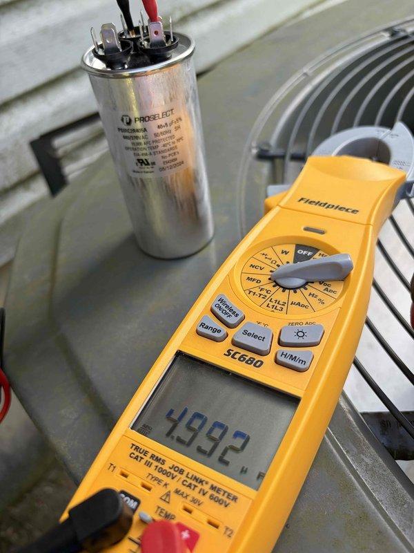 Completed comprehensive AC tune-up on residential condensing unit. Performed system diagnostics including capacitor testing with digital multimeter, verifying proper electrical values and component functionality. Unit operating within normal parameters with all components functioning properly.