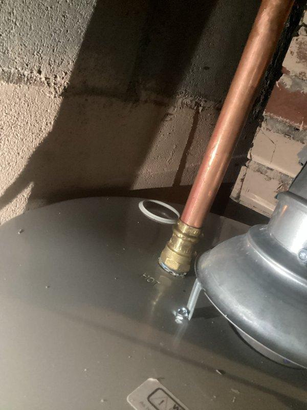 Completed follow-up service to address multiple safety and code violations identified during previous inspection of tanked water heater system. Installed discharge pipe on temperature and pressure relief valve to ensure proper drainage and code compliance. Addressed corroded water lines with seeping leak at water heater connections. Sealed water heater exhaust vent properly into chimney to prevent dangerous exhaust gases from entering basement space. Replaced cracked 4-inch furnace exhaust pipe near chimney connection point to restore safe venting operation on 3-year-old furnace unit. Documented ongoing chimney condition requiring future attention. All critical safety hazards resolved to protect occupants from potential carbon monoxide exposure and water damage.
