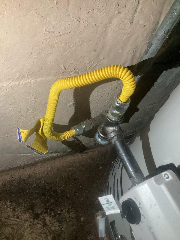 Completed follow-up service to address multiple safety and code violations identified during previous inspection of tanked water heater system. Installed discharge pipe on temperature and pressure relief valve to ensure proper drainage and code compliance. Addressed corroded water lines with seeping leak at water heater connections. Sealed water heater exhaust vent properly into chimney to prevent dangerous exhaust gases from entering basement space. Replaced cracked 4-inch furnace exhaust pipe near chimney connection point to restore safe venting operation on 3-year-old furnace unit. Documented ongoing chimney condition requiring future attention. All critical safety hazards resolved to protect occupants from potential carbon monoxide exposure and water damage.
