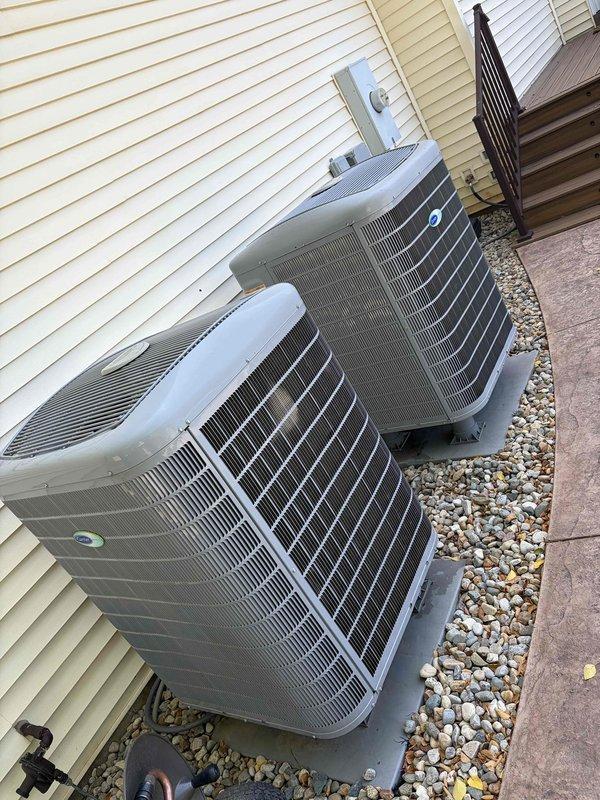 Completed final prepaid cooling maintenance visit for one of two residential systems on property. Performed standard preventive maintenance procedures on outdoor condenser unit, including inspection of electrical connections, refrigerant levels, and overall system operation. Documented equipment condition with temperature readings and exterior unit photographs showing both condensers positioned on rock bed against building exterior with proper clearances maintained.