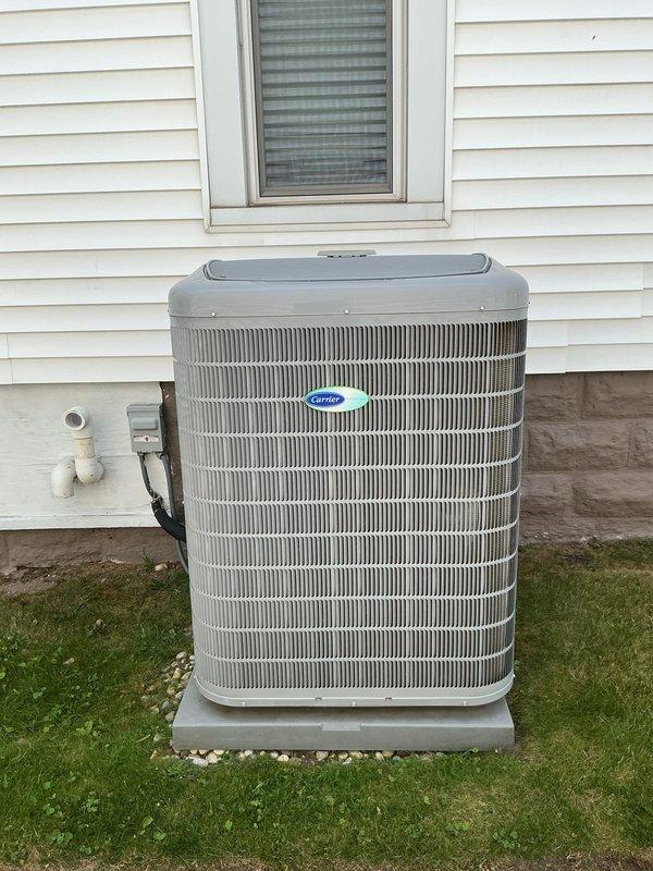 Completed annual air conditioning maintenance on residential Carrier condenser unit and associated indoor HVAC system. Performed comprehensive system inspection including evaluation of outdoor condenser components, heat exchanger coils, refrigerant lines, and indoor furnace connections. Verified proper operation of all equipment, confirmed adequate airflow through ductwork system, and documented system condition with photographic records showing unit in good working order with no immediate service needs identified.