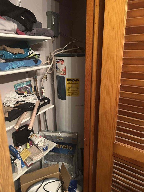 Conducted comprehensive site evaluation for complete HVAC system replacement including furnace, air conditioning unit, and water heater. Assessed existing equipment conditions, documented current thermostat location and utility closet configuration with tank-style water heater and associated plumbing connections, and provided replacement options and recommendations to homeowner.
