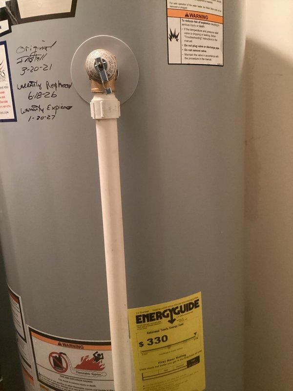 Responded to report of water leaking from valve at top of recently installed water heater. Upon inspection, identified active leak at temperature and pressure relief valve connected to white discharge pipe on Smith brand water heater installed in May 2021. Assessed T&P valve operation and discharge piping configuration. Documented equipment conditions and leak source with photographs for service records.