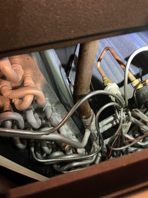 Completed first prepaid cooling system maintenance visit during scheduled afternoon appointment window. Performed comprehensive inspection of HVAC unit interior, examining refrigerant lines, copper piping, heat exchanger coils, and electrical connections. All copper pipes, including U-bend configurations and suction/liquid lines, were visually assessed for proper condition and signs of wear or oxidation. Verified refrigerant line insulation integrity and checked for moisture accumulation on components. Inspected aluminum fin coil structure and internal compartment housing for proper operation. System components found to be functioning within normal parameters with appropriate condensation present during cooling cycle operation.