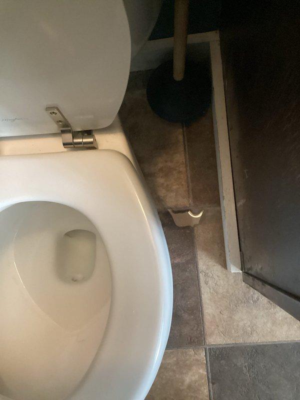 Responded to a leak at the base of a first-floor half bath toilet. Upon inspection, identified water seepage around the toilet base onto the tile flooring. Removed and reset the toilet with a new wax ring seal to eliminate the leak at the floor connection. Tested the fixture after reinstallation to confirm proper seal and no further water discharge at the base.