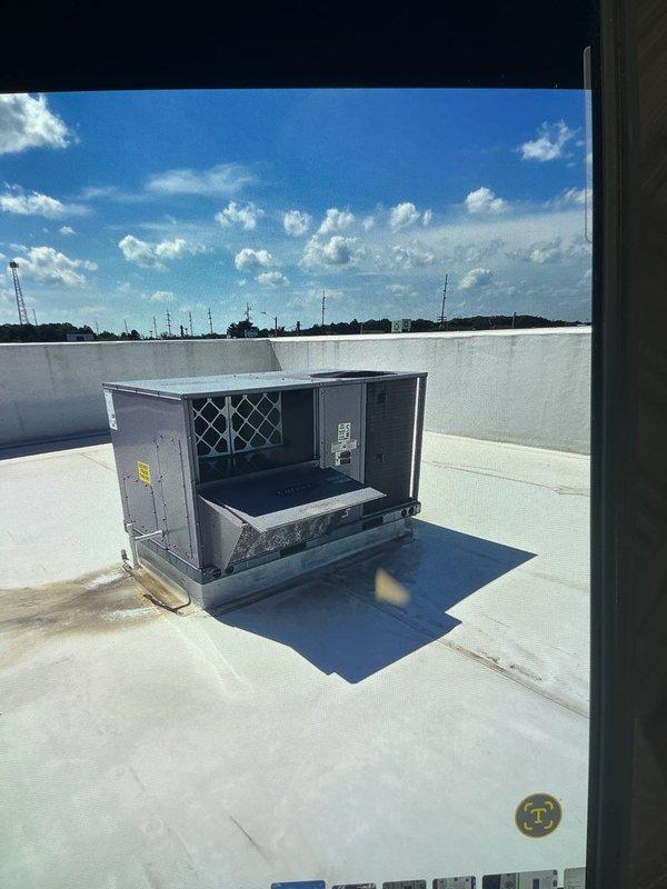 Responded to no cooling complaint on front commercial rooftop unit. Accessed rooftop packaged HVAC system, performed diagnostic testing with multimeter showing 600V reading, and inspected internal components with access panels open. Verified rear unit operating normally and restored cooling operation to affected front unit.