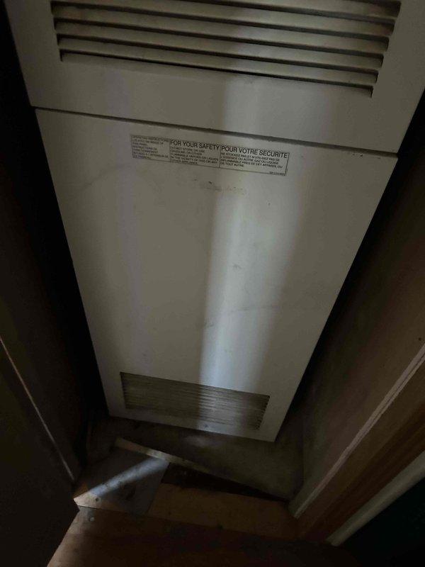 Tech lead Larry completed an HVAC system replacement estimate, documenting the existing indoor air handler unit showing significant wear and surface contamination, along with the outdoor condensing unit situated in an overgrown area with inadequate clearance from surrounding vegetation. The assessment included photographic documentation of both components to support replacement recommendations, noting the compromised serviceability due to environmental conditions and equipment age.