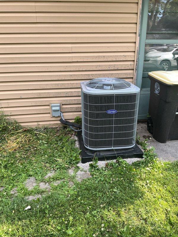 Completed full HVAC system replacement including installation of Carrier 26SCA424N003 Comfort Series single-stage air conditioner, Carrier CVAVA3017XMA evaporator coil, and Carrier 58SB0B070M17-12 Comfort single-stage gas furnace with 70,000 BTU capacity. Removed and recycled existing equipment, then positioned new outdoor condenser unit on vibration-dampening platform with proper clearances. Installed new electrical disconnect and whip for outdoor unit. Reconnected to existing refrigerant line set after performing complete flush and pressure test to verify system integrity. Mounted evaporator coil in air handler cabinet and connected to furnace system. Installed Honeywell 4-inch media air cleaner for improved indoor air quality. Reconnected all existing supply and return ductwork to new equipment with proper sealing. Upgraded to Honeywell T6 programmable thermostat with complete wiring and configuration. Installed new condensate drain system with proper pitch and termination. Verified