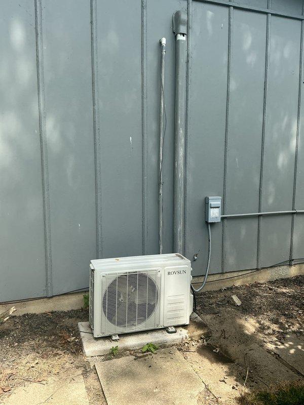 Responded to service call for non-cooling Royen brand ductless mini-split system in living room. Assessed indoor wall-mounted evaporator unit and outdoor Rovsun condenser unit, documented existing installation with photos, and provided estimate for complete system replacement due to equipment failure.