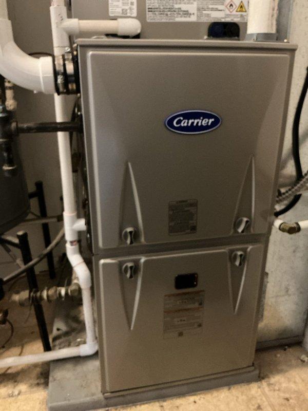 Completed full HVAC system replacement in residential utility room, installing new Carrier Performance 97 Series two-stage gas furnace (model 59TP7A060V17--16), Carrier Comfort Series single-stage air conditioner (model 26SCA424N003), and Carrier evaporator coil (model CVAVA3017XMA). Removed and recycled existing equipment, reconnected to existing line set after flushing and pressure testing, and reconnected all existing supply and return ductwork. Installed new 2" PVC condenser pad with pea gravel base, new disconnect and whip for outdoor unit, and completed furnace changeout with #2 installation kit for 80% to 90% efficiency upgrade. Routed white PVC venting and condensate drainage piping, secured all gas line connections with shutoff valves, and verified proper operation of all system components. Applied floor protection throughout work area and completed thorough cleanup of installation site. Provided comprehensive system operation explanation and thermostat programming instruction