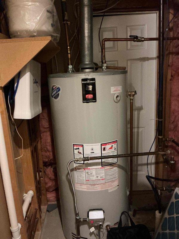 Completed air conditioning tune-up and performed routine maintenance inspection of the HVAC system. Provided customer education on proper air filter replacement procedures and demonstrated the correct technique for accessing and changing the filter for their specific unit. Documented equipment condition with photographs of related utility systems including water heater and electrical panel for service records.