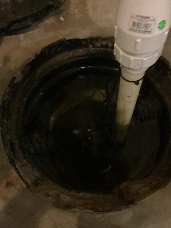 Responded to emergency call for non-operational sump pump system with basin at full capacity. Upon arrival, found sump pump failed to activate despite water level reaching critical height in pit. Removed and inspected existing pump unit, confirming complete pump failure. Installed new replacement sump pump in basin, connected discharge piping to existing white PVC vertical discharge line, and verified proper float switch operation. Tested system through multiple cycles to ensure automatic activation at appropriate water levels and confirmed adequate pumping capacity and discharge flow. System restored to full operational status with basin pumped down to normal low-water level.