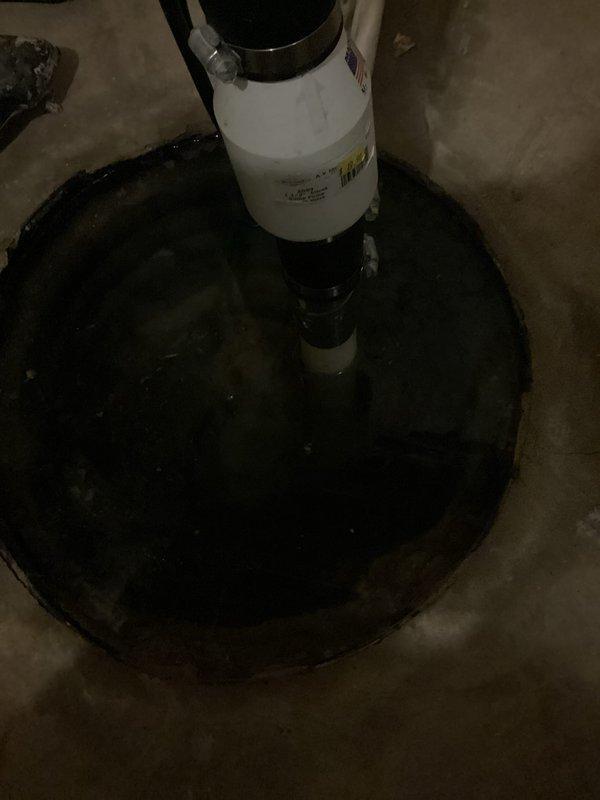Responded to emergency call for non-operational sump pump system with basin at full capacity. Upon arrival, found sump pump failed to activate despite water level reaching critical height in pit. Removed and inspected existing pump unit, confirming complete pump failure. Installed new replacement sump pump in basin, connected discharge piping to existing white PVC vertical discharge line, and verified proper float switch operation. Tested system through multiple cycles to ensure automatic activation at appropriate water levels and confirmed adequate pumping capacity and discharge flow. System restored to full operational status with basin pumped down to normal low-water level.