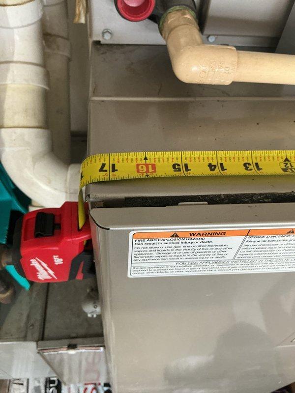 Conducted on-site evaluation for complete HVAC system replacement following initial no-cool service call that was temporarily resolved by lead technician. Assessed existing Carrier air handler and furnace unit located in multipurpose utility closet with limited clearance. Documented equipment dimensions and spatial constraints, including surrounding ductwork configuration with galvanized metal rectangular ducts and white PVC piping. Photographed current installation showing standard residential HVAC setup with warning labels visible on gas-fired equipment. Evaluated accessibility challenges due to shared storage space with household items and measured equipment dimensions for replacement sizing. Prepared comprehensive estimate for furnace and air conditioning system replacement at primary residence. Additional estimate requested for separate lake house property to install new air conditioning system.