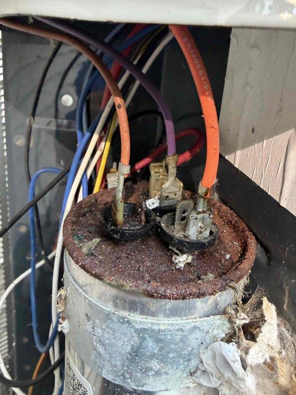 Completed final prepaid cooling maintenance visit on residential HVAC system. Performed standard system inspection and temperature diagnostics, recording supply air temperature of 73.4°F. Upon inspection of outdoor condensing unit, discovered capacitor with severe corrosion and rust deterioration on terminals and top surface, indicating exposure to moisture and age-related failure requiring immediate replacement to prevent system breakdown.