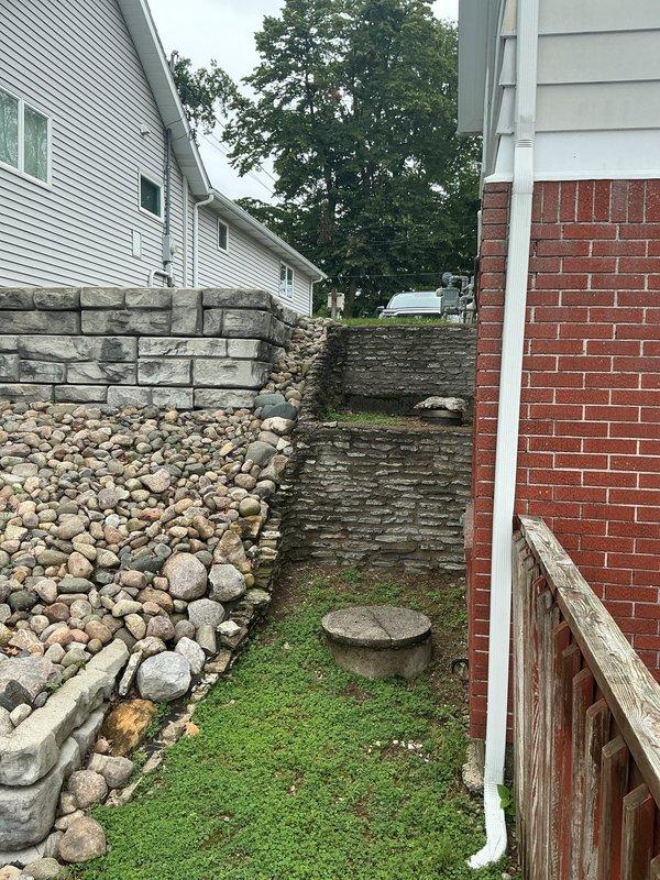 Completed on-site assessment for air conditioning system addition to existing residential property. Evaluated exterior installation pathway between structures, noting narrow access area with landscaping and adequate clearance for equipment placement and line set routing. Documented interior access points and confirmed feasibility for ductwork integration and thermostat installation to support HVAC expansion estimate.