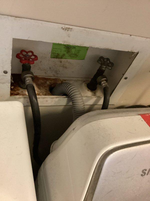 Responded to emergency water leak in basement originating from dishwasher supply line. Upon arrival, observed active water intrusion through ceiling light fixture and visible water staining along suspected water line path. Isolated leak source by shutting off dishwasher supply valve, which successfully stopped active water flow. Inspected utility connection area and documented water damage to ceiling materials and rust staining at pipe connections. Advised homeowner that ceiling access may be required for complete repair and assessment of supply line condition. Photographed affected areas including supply valve configuration and ceiling water damage for documentation purposes.