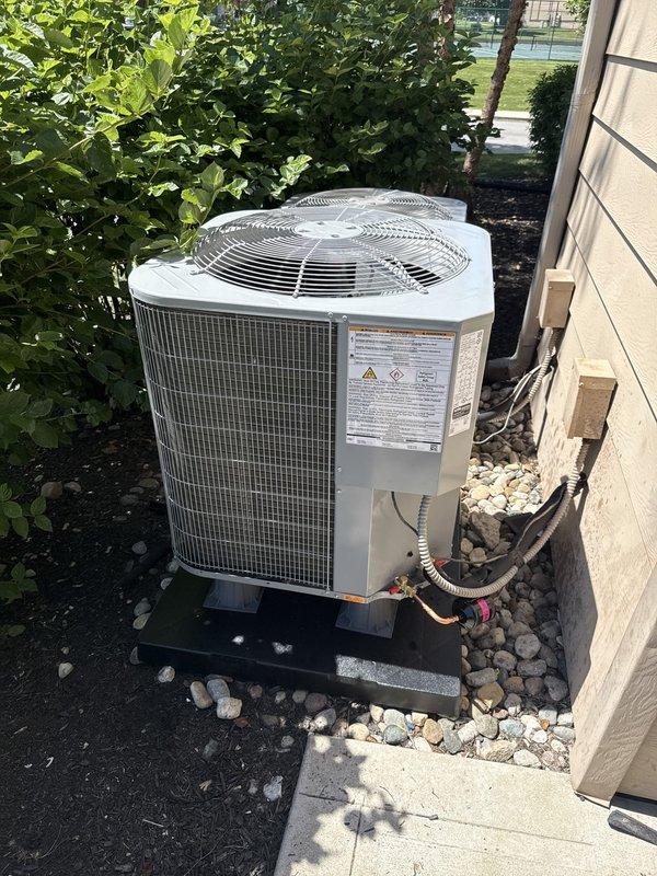 Completed installation of a Carrier 2.0-ton, 15 SEER heat pump system with R454B refrigerant, including a wall-mounted air handler equipped with 8kW electric heaters and a Honeywell T6 Pro digital thermostat. Reconnected unit to existing supply air ductwork, flushed and pressure tested existing refrigerant lines before reconnection, and restored all high and low voltage wiring connections. Applied proper labeling to heat pump unit and verified system operation upon completion.