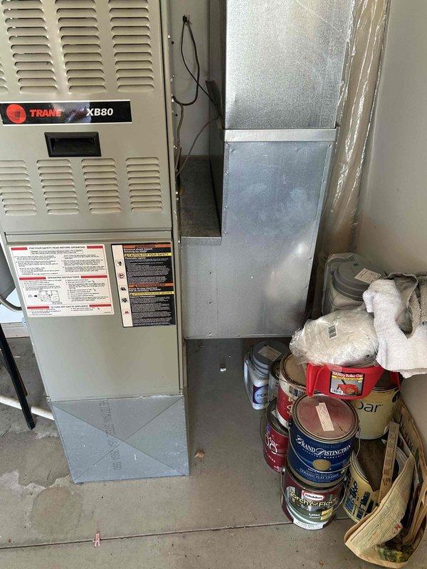 Conducted on-site assessment for air conditioning system replacement. Evaluated existing Trane XB80 furnace and associated ductwork, noting visible corrosion on galvanized metal elbow joint with rust penetration through protective coating. Provided comprehensive replacement estimate with equipment options and installation specifications.