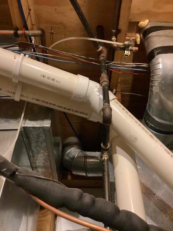 Conducted on-site assessment of existing tanked water heater system for potential tankless water heater conversion. Evaluated current plumbing configuration including copper supply lines, PVC drainage system, gas connections, and electrical wiring requirements. Documented existing installation conditions, pipe routing, venting arrangements, and available utility space to develop comprehensive replacement estimate for tankless water heater installation.