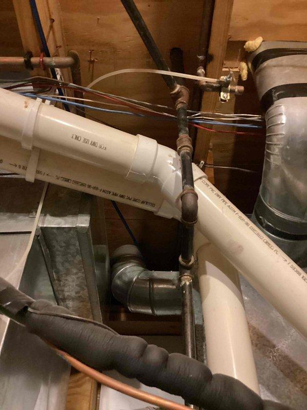 Conducted on-site assessment of existing tanked water heater system for potential tankless water heater conversion. Evaluated current plumbing configuration including copper supply lines, PVC drainage system, gas connections, and electrical wiring requirements. Documented existing installation conditions, pipe routing, venting arrangements, and available utility space to develop comprehensive replacement estimate for tankless water heater installation.