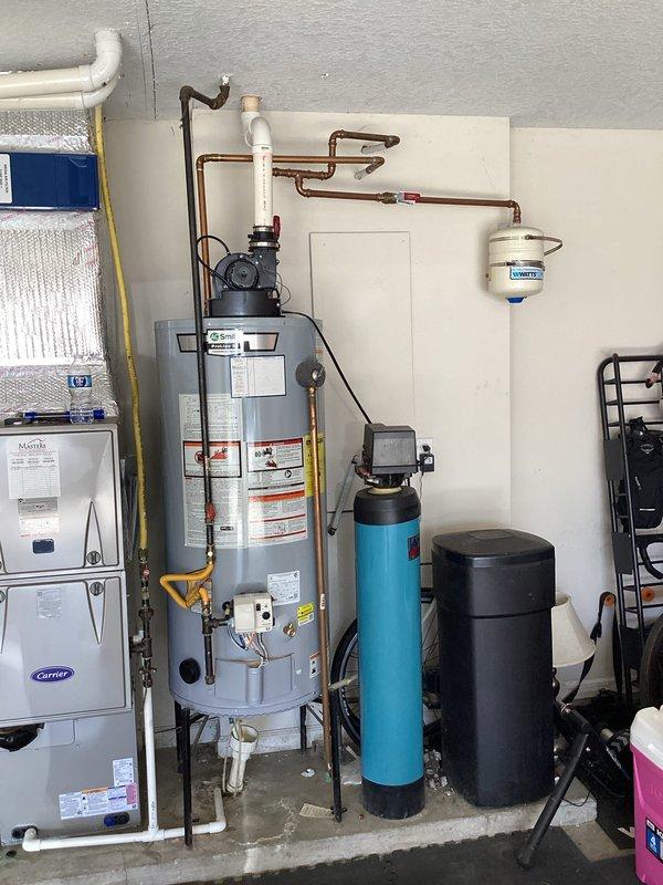 Responded to service call for gas water heater with automatic electric ignition displaying 7 flashes error code. Inspected GPVL-40 200 model 40-gallon power vent water heater previously installed in utility area. Diagnosed ignition system fault, verified gas supply and electrical connections, cleared error code, and tested unit operation to ensure proper functionality. Documented equipment condition with photos showing water heater, associated plumbing connections, copper piping, and yellow gas line installations.